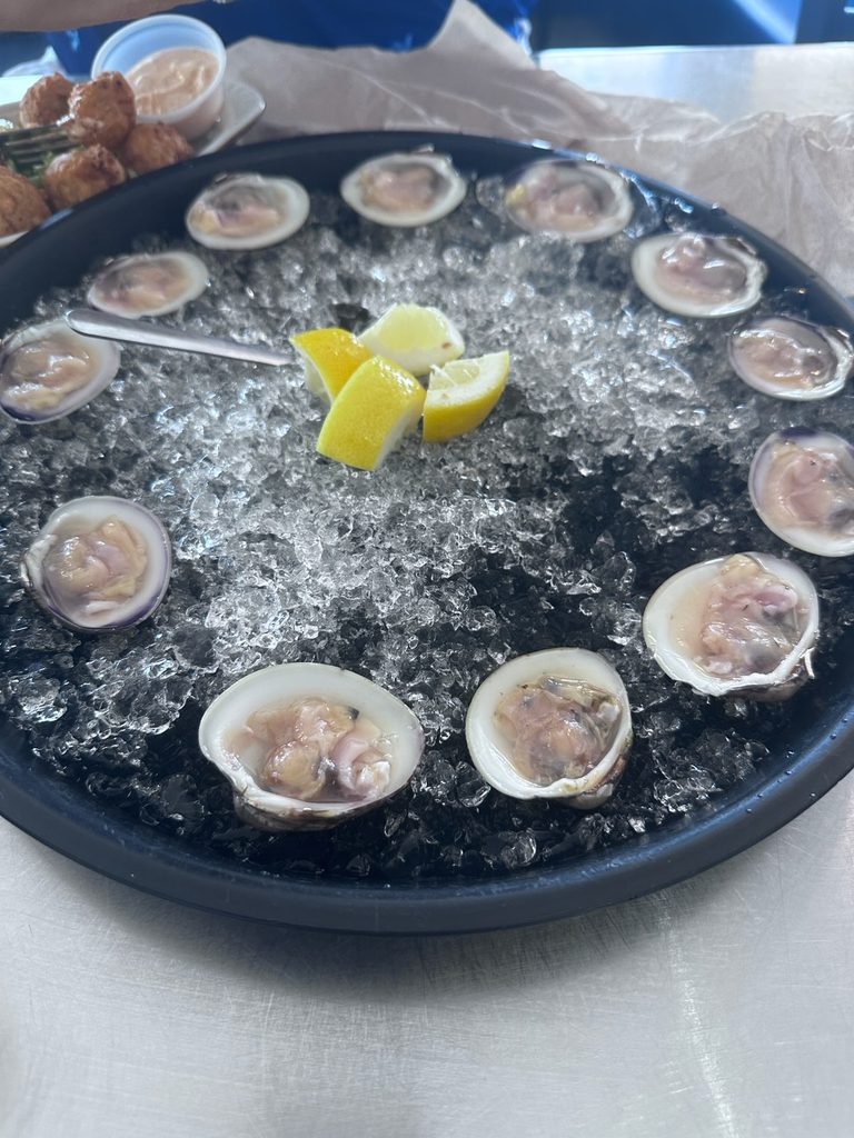 Raw clams served on ice with lemon at The Commander’s Shellfish Camp.